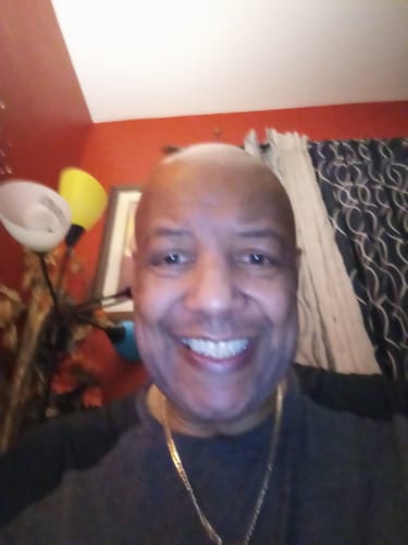 Reviewer smiling, reflecting their satisfaction with the Champagne Kush Caviar Collection Pre Rolls.