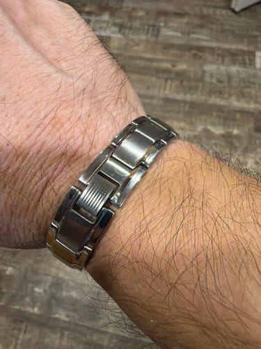 Customer's silver Iron Man Armor Titanium Magnetic Bracelet on their wrist, showing an engraved American flag detail.