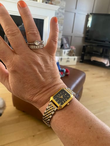 Customer's gold and silver-tone Claire De Mains watch on wrist, wearing a ring