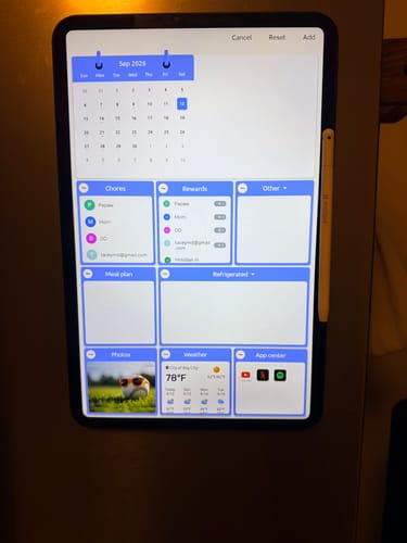 Customer's FridgeCal AI Fridge Calendar mounted on a refrigerator, displaying a digital calendar and chore list.