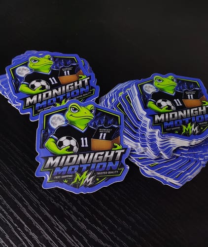 Customer's stacks of Midnight Motion custom vinyl stickers featuring a frog character with a soccer ball.