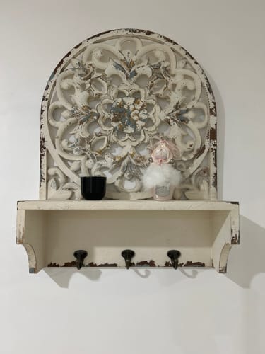 Customer's Dimitri wall shelf mounted on a plain wall with a small black candle and a decorative item on the shelf.