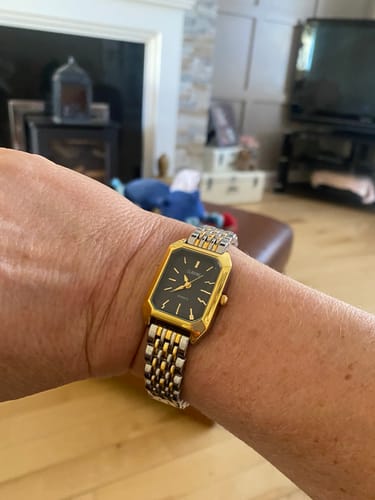 Customer's gold and silver-tone Claire De Mains vintage watch on wrist