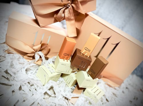 Customer's Forming Gel Light Rose products, including small boxes and bottles, arranged among elegant gift packaging.