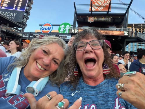 Reviewer's happy friends at a baseball game, referencing DeepSleep Gummies for a restful night.
