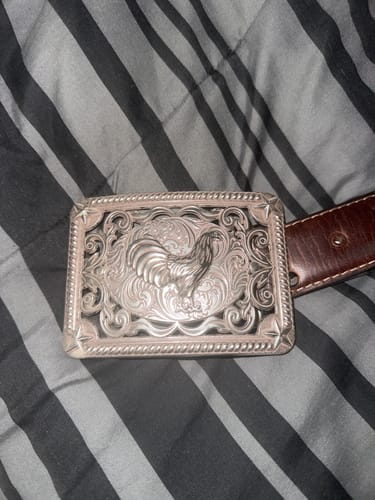 Customer's silver rectangle belt buckle with detailed rooster design on a brown leather belt.