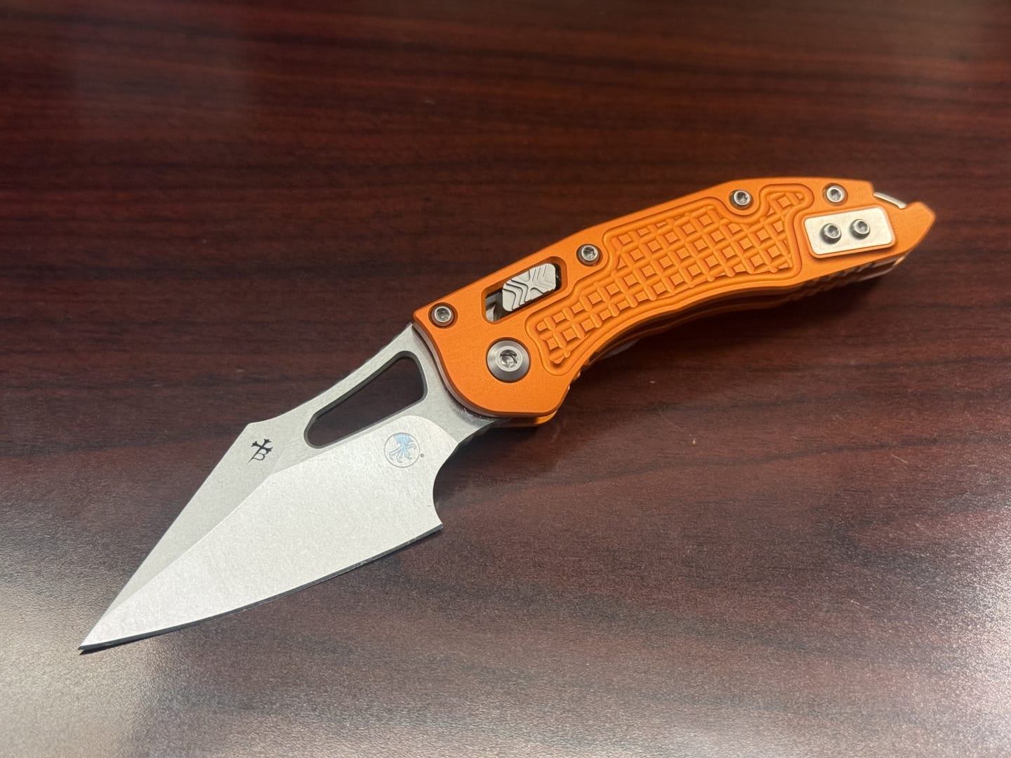 Customer photo review of Microtech M-Stitch Ram-Lok Knife – 3" M390MK Blade, Stonewash, Orange Frag Aluminum – Made in USA (169MRL-10FROR)