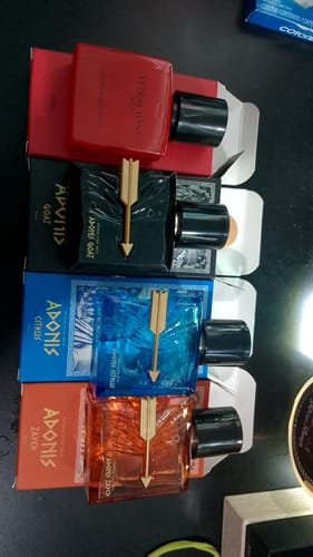 Customer's Kit Adonis and Attracione fragrances shown in four colorful perfume bottles with matching boxes.