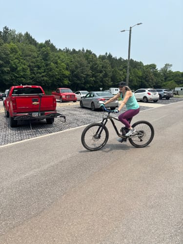 Customer's active lifestyle, riding a bike outdoors, which they attribute to the help of Super Grape Ape gummies.