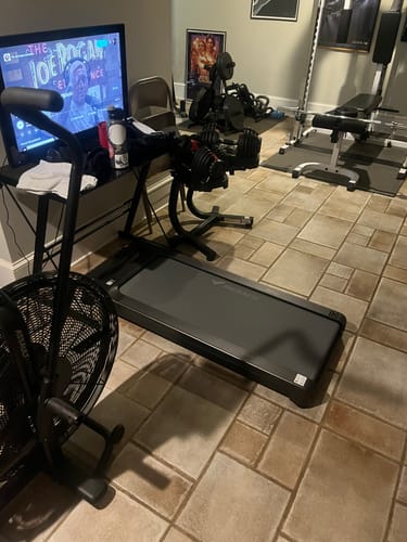 Customer's black Merach UltraWalk W60 Plus treadmill placed on a tiled floor in a home gym.