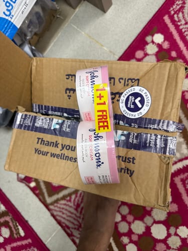 Customer's Johnson's Soft Cream moisturizer box showing a 1+1 free promotional offer.