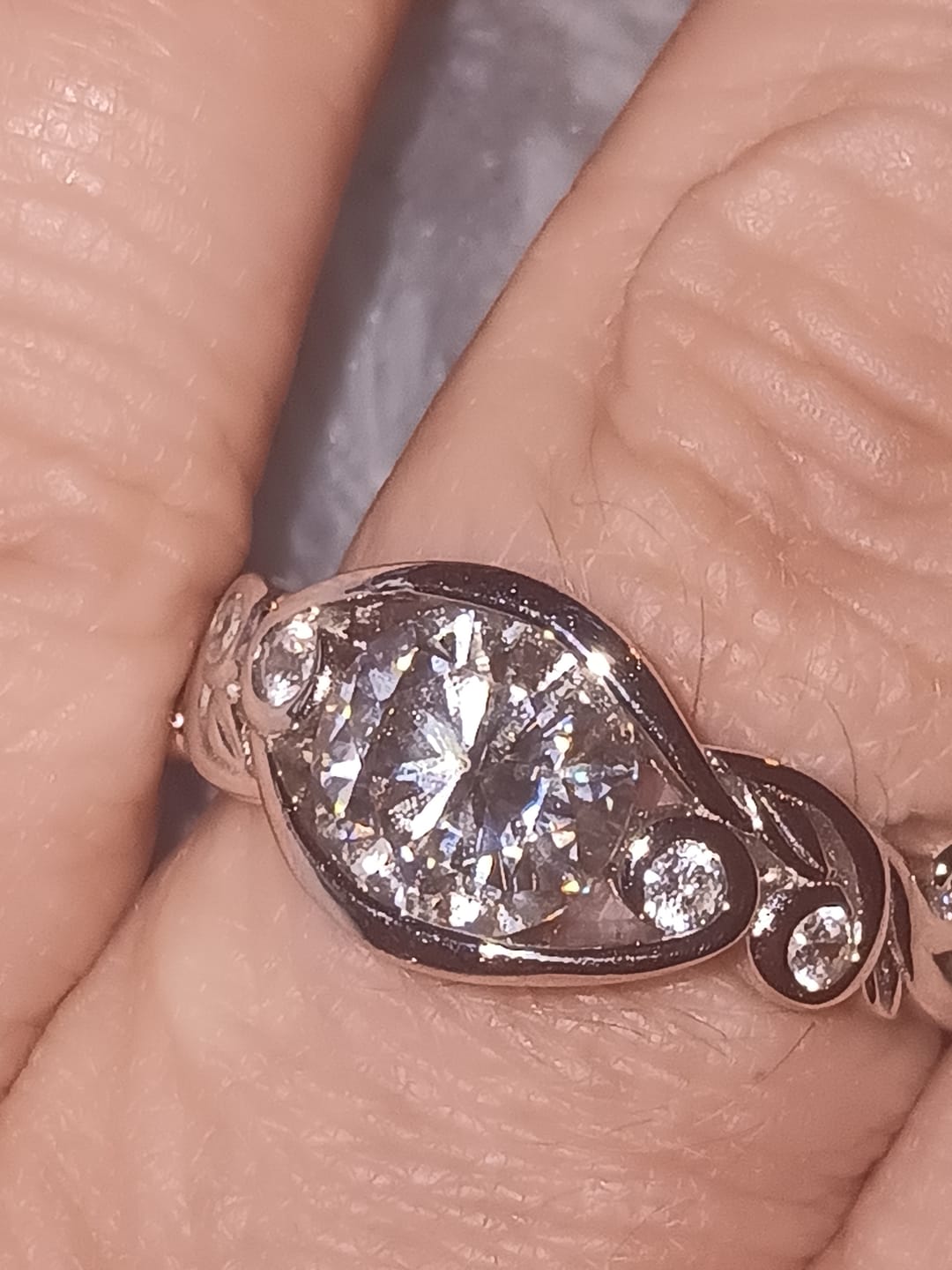 Customer photo review of Bezel Set Round Moissanite Scroll Accents Engagement Ring