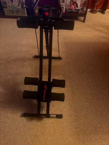 Customer's black dual-track ab machine for core training, standing on carpeted flooring.