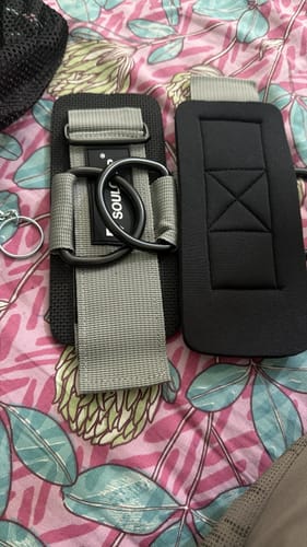 Customer's pair of Soulcuff Dual Support Wrist & Ankle Cuffs in grey and black on a floral patterned surface.