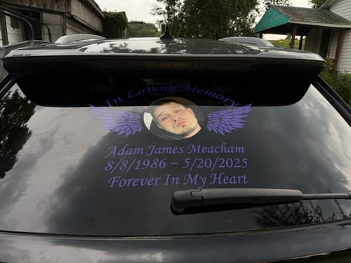 Customer's purple custom In Loving Memory decal applied to the rear window of a car.