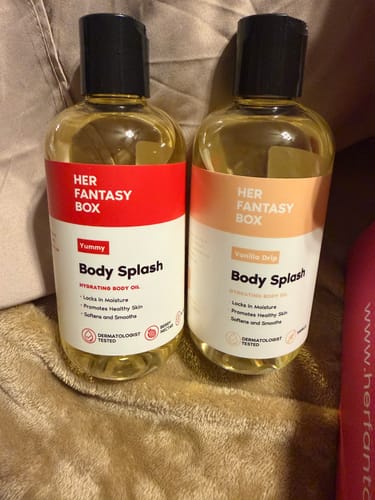 Customer's two bottles of Skin Smoothing Body Oil, including the Vanilla Drip scent, sitting on a soft surface.