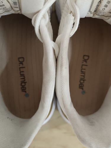 Customer's Ortopéd Pro Talpbetét insoles placed inside white shoes showing branding.