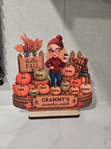 Customer's Hello Fall Grandma's Pumpkin Patch wooden plaque on a counter, featuring custom names on orange pumpkins.