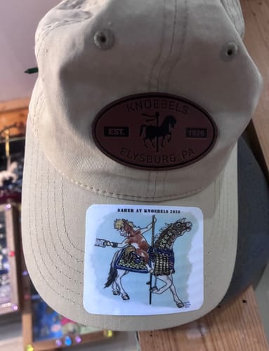Customer's custom vinyl sticker featuring a carousel horse illustration applied to a tan baseball cap.