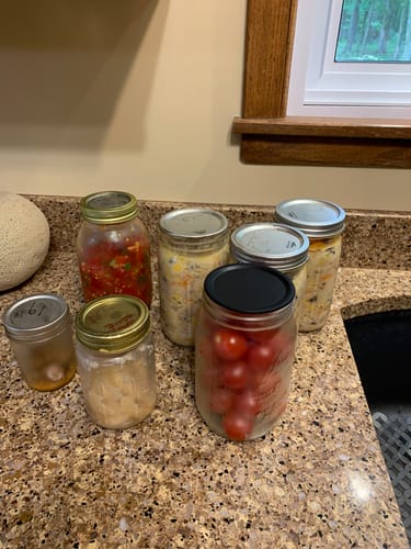 Customer's Mason Genie Vacuum Sealer Kit used to seal various mason jars filled with food on a kitchen counter.