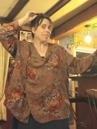 Reviewer wearing a brown floral V-neck cotton blouse in an oversized fit.