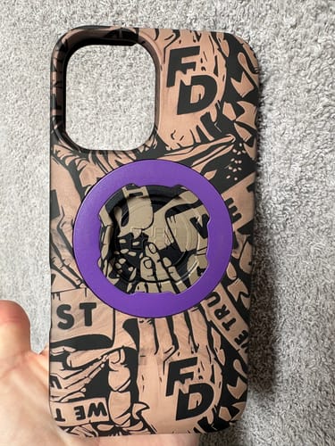Customer's Quad Lock phone case with a brown patterned laser engraving and a purple central mount component.