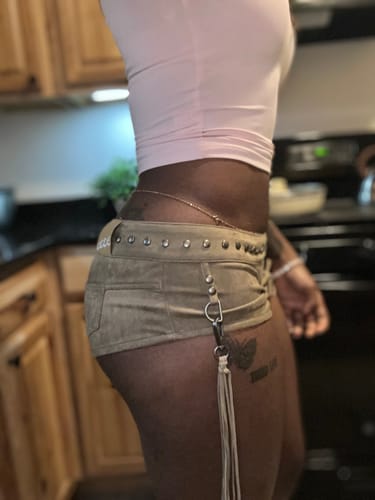 Customer's tan suede Vice Short featuring silver studs and a fringe accent, worn as a low-rise style.
