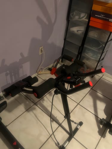 Customer's black Dual-Track Ab Machine on a tiled floor in a room