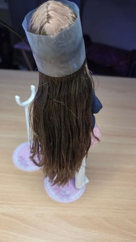 Customer's Don't Touch My Bangs 1/6 scale action figure seen from behind, showing long brown hair and plastic stand.