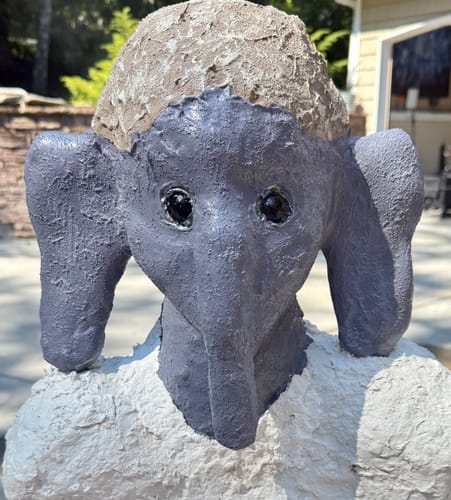 Customer's artistic statue with grey, textured head and white, sculpted shoulders.