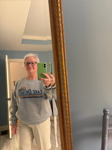 Customer wearing the grey Lake Ontario Retro Stripe Sweatshirt in a mirror reflection.