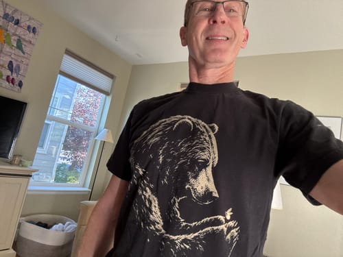 Reviewer wearing a black Bear Hug T-Shirt featuring a detailed bear graphic.