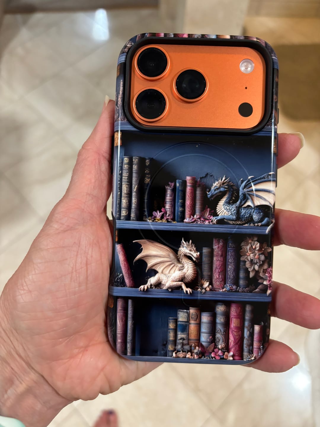 Customer photo review of The Dragon's Keep – Fantasy Bookshelf Design iPhone Case