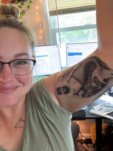 Ashley’s custom mermaid tattoo on her arm