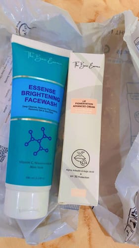 Customer's Advance Lip Pigmentation Cream box displayed next to a bright teal Essense Brightening Facewash bottle.