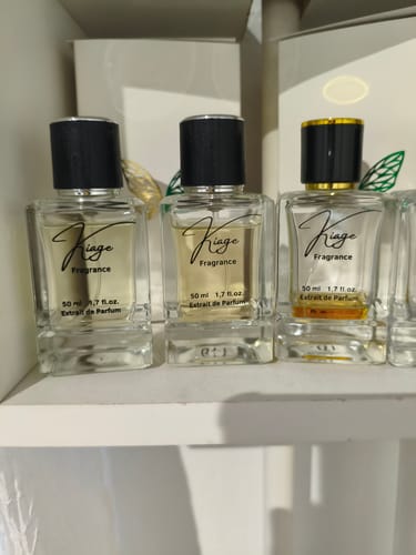 Customer's three refillable Taschenzerstäuber perfume bottles on a white shelf.
