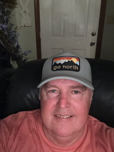 Customer's Big Foam Trucker Hat in grey with a Go North patch worn on their head.