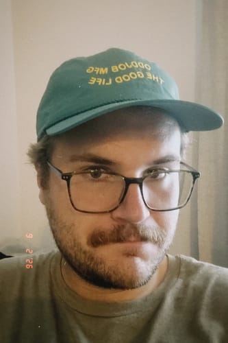 Customer's Big Lightweight Nylon Hat in green with yellow lettering, worn on the reviewer's head.