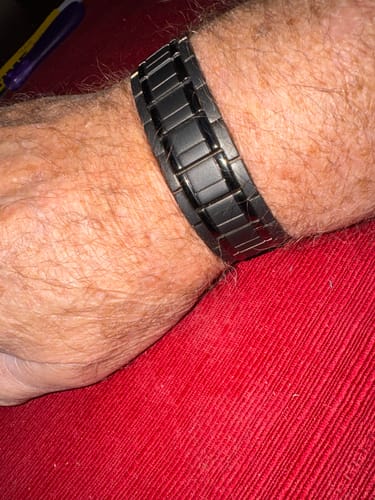 Reviewer's black titanium magnetic bracelet worn on their wrist.