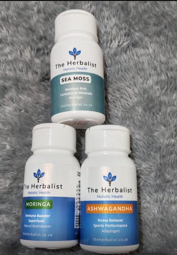 Customer's Reset Bundle featuring three white supplement bottles of Sea Moss, Moringa, and Ashwagandha on a gray surface.