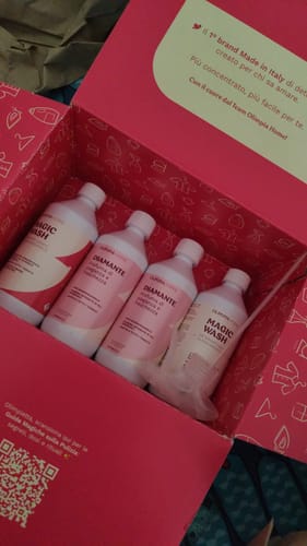 Customer's Diamante products inside a branded open pink box containing four bottles of detergent