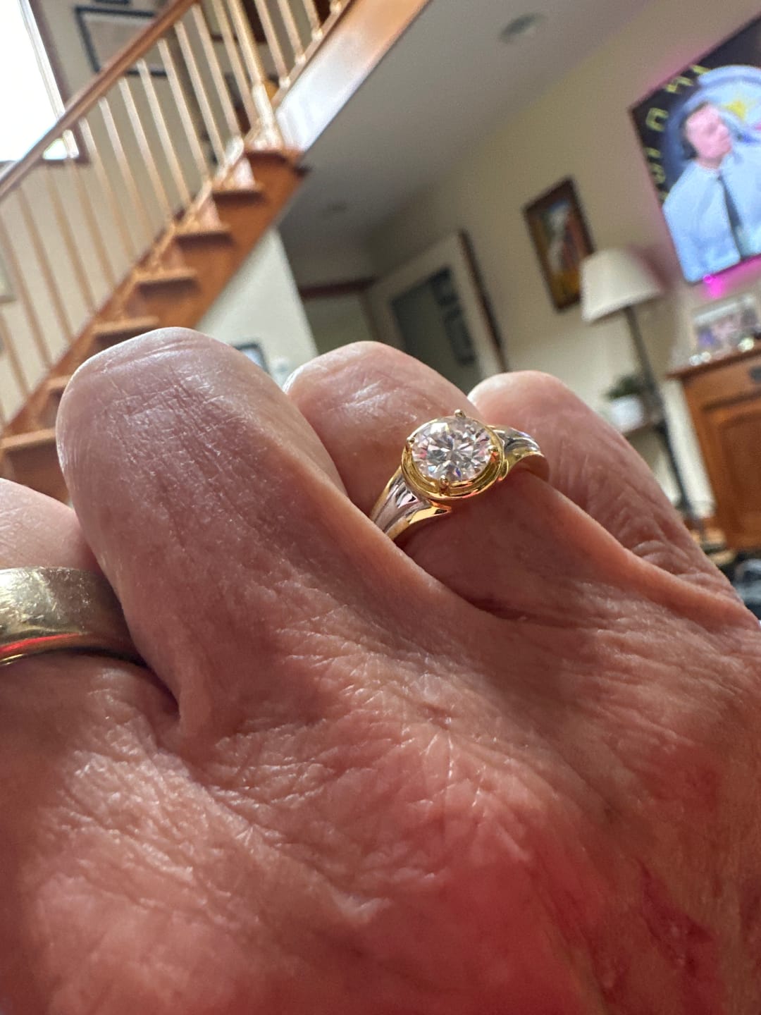 Customer photo review of Solitaire Round Moissanite Streamlined Two-Tone Engagement Ring