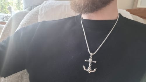 Customer's Skulled Anchor pendant on a silver chain worn around the neck.