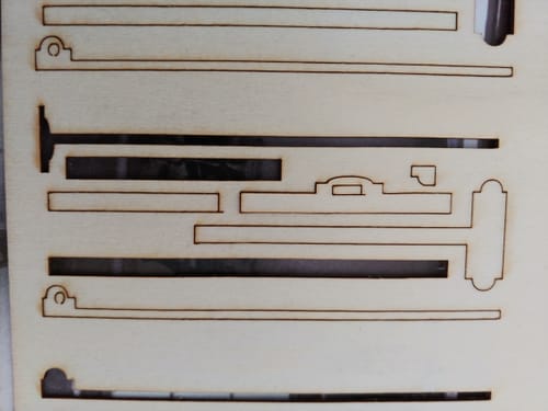 Customer's AtomStack Swift laser-cut wood pieces on a flat surface