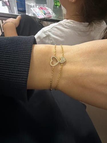 Customer's gold-tone Mother's Day Gift bracelet featuring a dainty heart charm on a delicate chain worn on the wrist