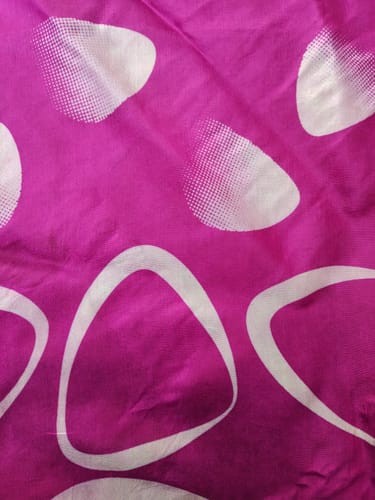 Customer's Pure Silk Scarf featuring a vibrant pink fabric with white circular and triangular patterns