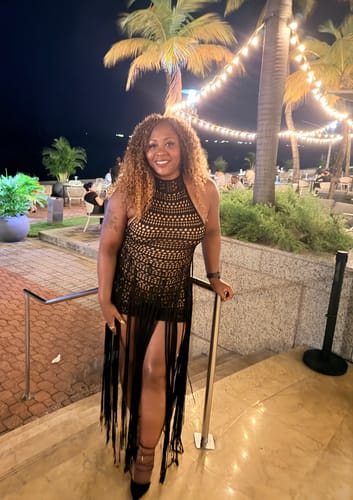 Customer's Crochet Fringe Halter Mini Dress, showing the halter neckline and fringe detailing at dinner.