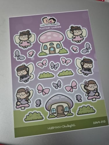 Customer's Fluttery Garden sticker sheet showing cartoon fairies, butterflies, and mushroom houses.