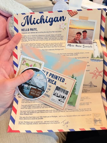 Customer's Josh & Jase Mail Club Michigan letter and sticker being held in a hand