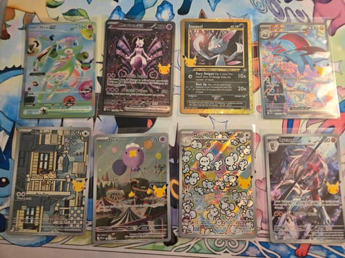 Customer's Pokemon 30th Celebration Elite Trainer Box cards, showing eight rare foil trading cards on a gaming mat.